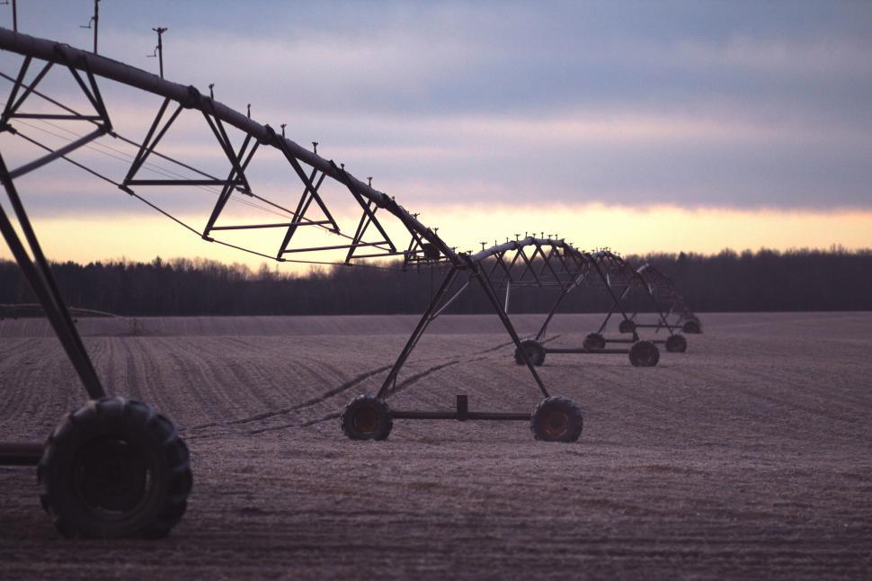 row of farm equipment in field